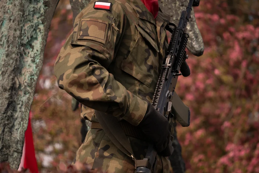 A soldier of the Polish forces walking with a rifle