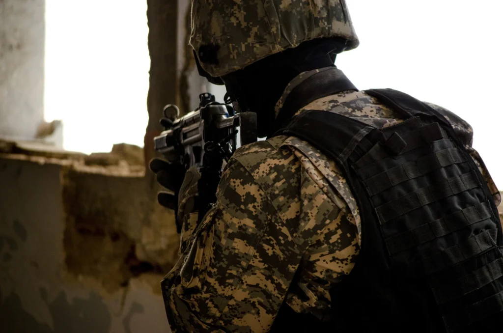 Soldier at war in the ruins of a building wearing a bulletproof vest