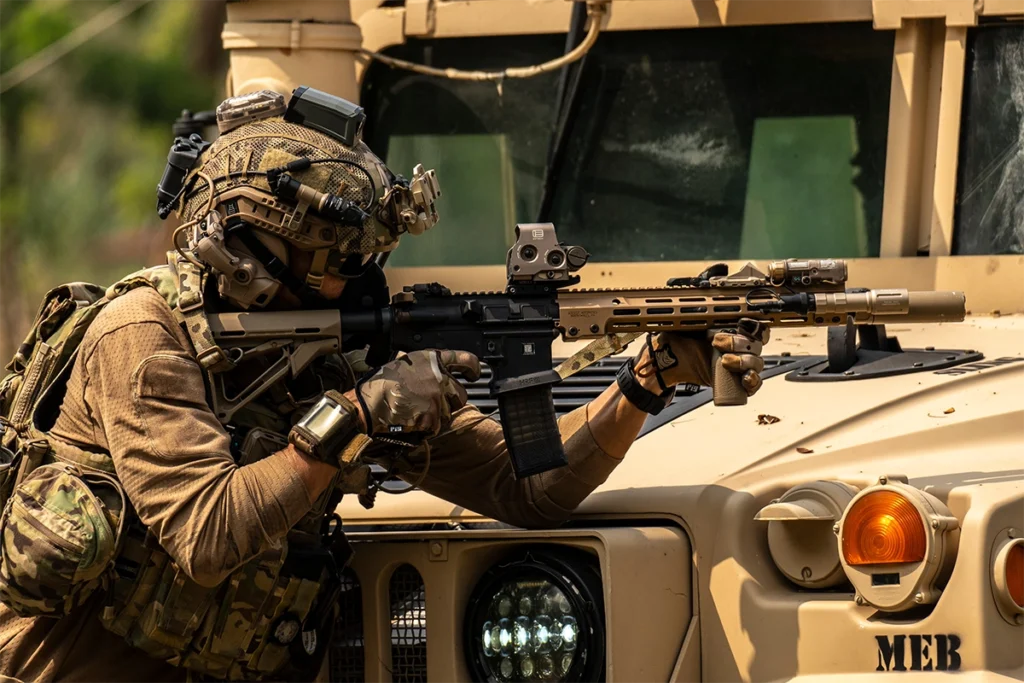 operator with weapon behind armored vehicle – tactical essentials in action