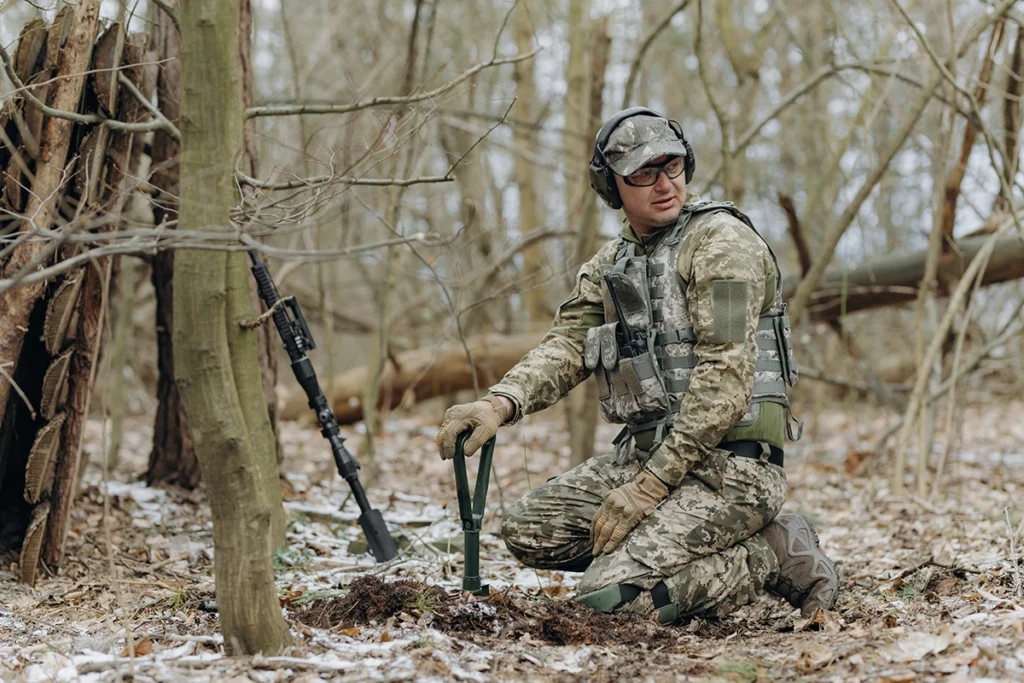 soldier in the forest using military gear to dig