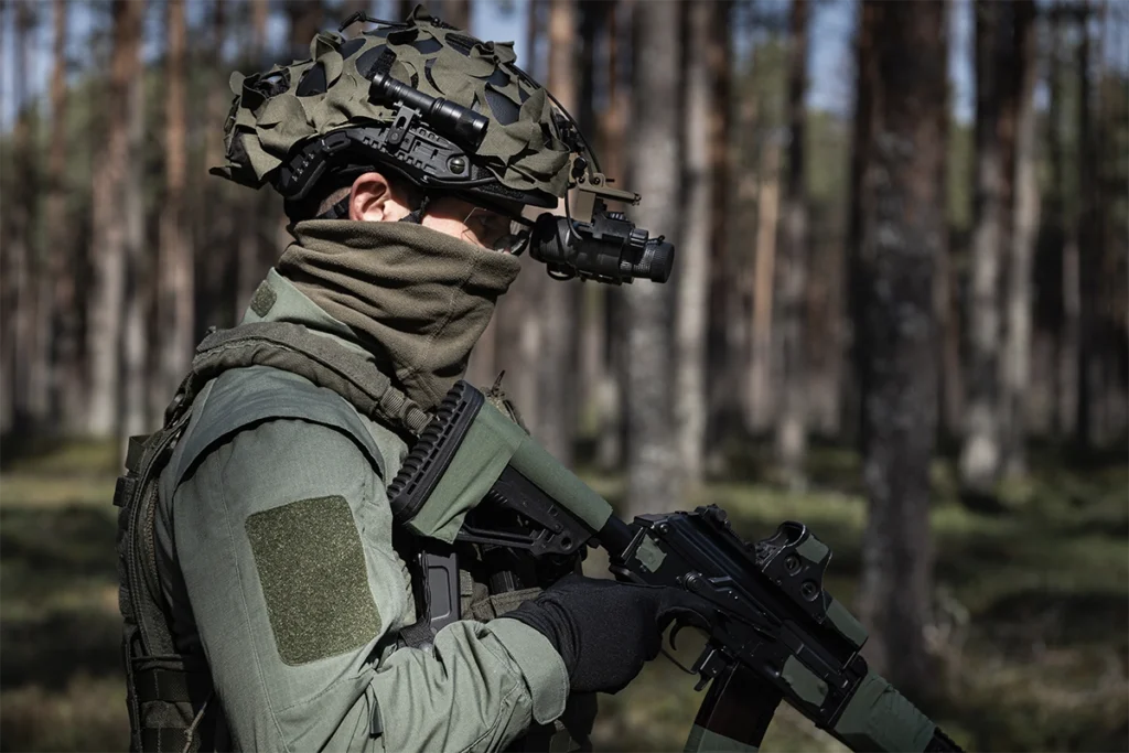 operator with weapon and warfare equipment wearing helmet with night vision