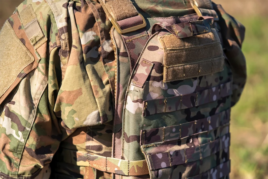 A man in a multicam plate carrier vest, which provides various NIJ ballistic protection levels.