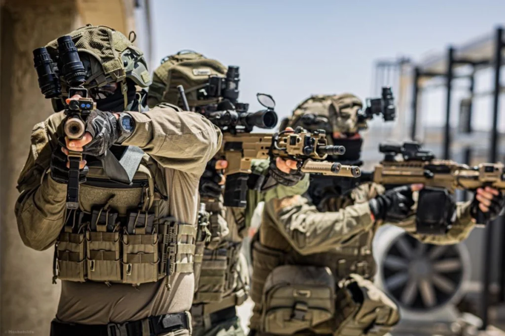 Special forces operators aiming weapons equipped with optical systems and a long gun flashlight